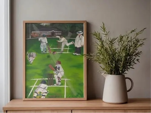 Bowled Over presented in a wooden frame beside a vase