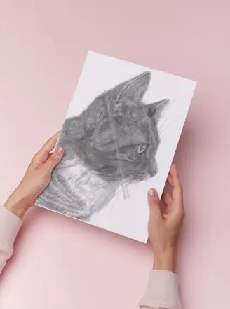 Black cat pencil portrait print held against a soft pink background